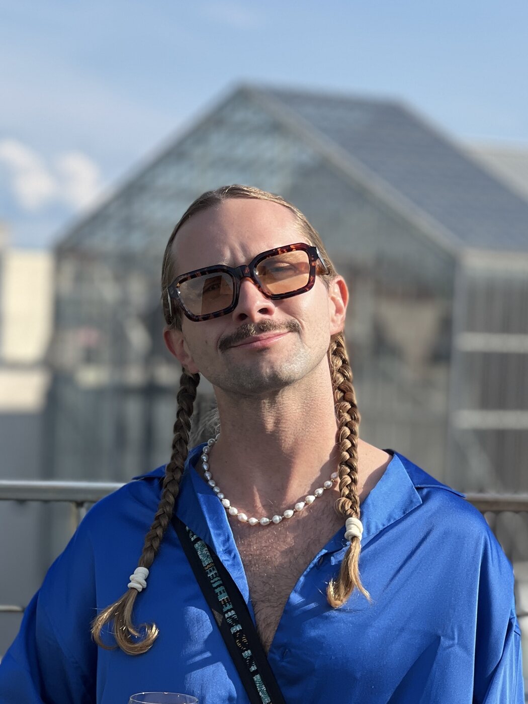 Simon Burkhardt, marketing consultant in Berlin — braids, moustache and a blue shirt, the face behind the Braided Together logo